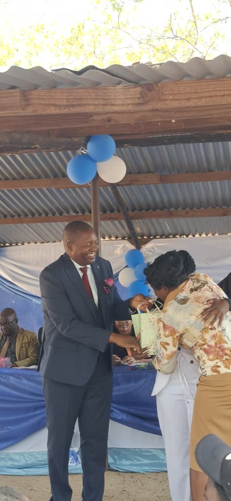 Colonel Rev Vudzaishe Mabuto Handing Prizes to learner as parent celebrate